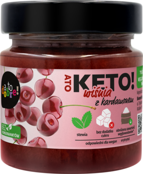 Keto konfitura wiśniowa z kardamonem, w szklanym słoiku z różową etykietą i wiśniami, widok z przodu.