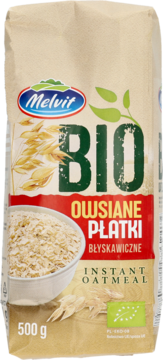 Beżowa papierowa torba Melvit Bio Owsiane Płatki Błyskawiczne 500g z miską owsianki i kłosami owsa, widok z przodu.