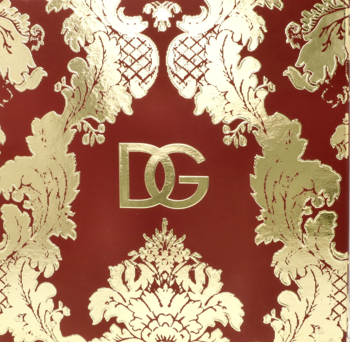 Czerwone kwadratowe opakowanie Dolce & Gabbana Light Blue ze złotym wzorem damask i logo DG pośrodku.
