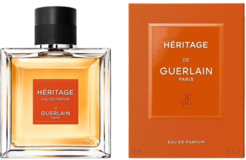 Perfumy Guerlain Héritage Men: szklana butelka z pomarańczową etykietą i pomarańczowe opakowanie, widok z przodu.