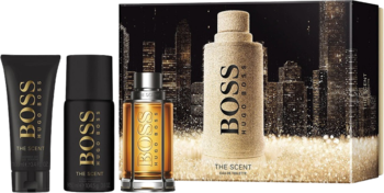 Zestaw Hugo Boss The Scent: czarny żel, dezodorant i brązowa butelka wody toaletowej; z prawej beżowe opakowanie z miastem.