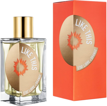 Butelka perfum Like This Etat Libre d'Orange: przezroczysta, złota etykieta, obok pomarańczowego pudełka.