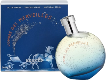 Perfumy Hermes L'Ombre des Merveilles: kulisty flakon w niebiesko-żółtych gradientach i granatowe pudełko z grafiką powozu.