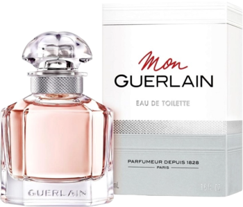 Guerlain Mon Guerlain Eau de Toilette: elegancka butelka perfum z różowym płynem obok białego pudełka, widok z przodu.