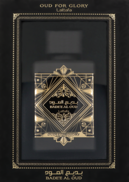 Lattafa Bade'e Al Oud for Glory, elegancki czarny flakon perfum z arabskimi zdobieniami widoczny przez okno złotego pudełka.