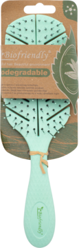 Front view: mint green biodegradable Biofriendly hairbrush in brown eco-packaging, unique bristle design.