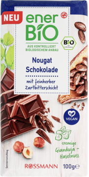 enerBio Nougat Schokolade 100g, wegańska, w białym opakowaniu z widokiem czekolady i orzechów laskowych.