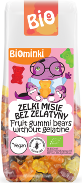 Biominki wegańskie żelki misie bez żelatyny, przezroczysta torba z różową etykietą i kolorowymi owocowymi misiami.