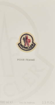 Front białego pudełka perfum Moncler Pour Femme, z logo marki i napisem "POUR FEMME".