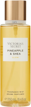 Victoria's Secret Pineapple & Shea Glow Fragrance Mist, żółta, w przezroczystej butelce z złotą nakrętką, widok z przodu.