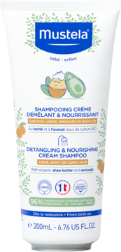 Mustela Detangling & Nourishing Cream Shampoo w białej tubie z liśćmi, masłem shea i awokado, widok z przodu.