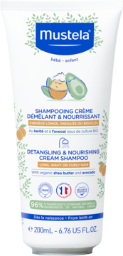 Mustela Detangling & Nourishing Cream Shampoo w białej tubie z liśćmi, masłem shea i awokado, widok z przodu.