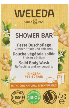 Żółto-pomarańczowe opakowanie kostki pod prysznic Weleda Solid Body Wash Ginger+Petitgrain z ilustracjami, widok z przodu.