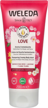 Weleda Aroma Love Creamy Body Wash 200ml, w jasnoróżowej tubie z różą i ylang-ylang, widok z przodu.