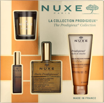 Zestaw Nuxe The Prodigieux Collection: złota świeca, butelki suchego olejku i perfum, pomarańczowy olejek pod prysznic na tle opakowania.