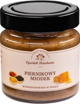 Miód piernikowy Ogródek Dziadunia w szklanym słoiku z czarną nakrętką. Na beżowej etykiecie grafika przypraw.