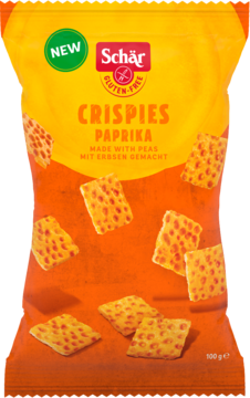 Pomarańczowa paczka Schär Crispies Paprika, bezglutenowych chrupek grochowych, widok z przodu, z rozsypanymi kawałkami.