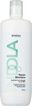 Biała butelka szamponu Indola Repair Shampoo 1000ml, z zielonym napisem, wegańska formuła redukująca uszkodzenia.