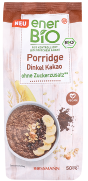 EnerBIO Porridge Dinkel Kakao bez cukru. Biało-brązowa torebka, front z miską czekoladowego porridge, bananami i orzechami.