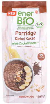 EnerBIO Porridge Dinkel Kakao bez cukru. Biało-brązowa torebka, front z miską czekoladowego porridge, bananami i orzechami.