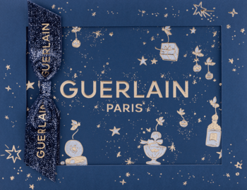 Guerlain Shalimar zestaw prezentowy. Granatowe pudełko z gwiazdkami i złotym logo Guerlain, przewiązane wstążką.