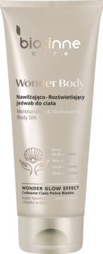 Jasno beżowa tubka Biotinne Care Wonder Body nawilżająco-rozświetlający jedwab do ciała z perłowymi drobinkami.