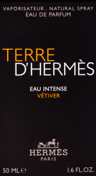 Męska woda perfumowana Hermès Terre D'Hermès Vétiver na czarnym opakowaniu, pomarańczowe i białe napisy.