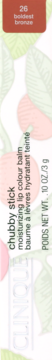 Clinique Chubby Stick moisturizing lip balm, shade 26 Boldest Bronze, label close-up on leafy background.