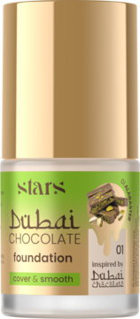 Kryjący podkład Dubai Chocolate Alabaster, butelka z złotą nakrętką i etykietą z czekoladą i pistacjami.