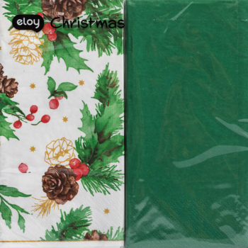 Serwetki papierowe Eloy Christmas: jedna z deseniem świątecznym (ostrokrzew, szyszki), obok gładkie zielone w folii.