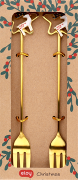 Dwa złote widelczyki Eloy Christmas z rączkami w kształcie białych reniferów w świątecznym pudełku. Widok z przodu.