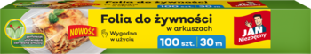 Żółto-zielone opakowanie folii spożywczej JAN Niezbędny w arkuszach, 100 szt. 30 m, z daniem w tle.