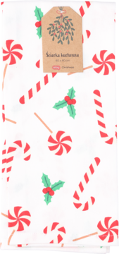 Biała ścierka kuchenna w świąteczne lizaki, cukrowe laski i ostrokrzew z brązową etykietą z jemiołą, widok z góry.