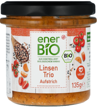 Bio pasta roślinna enerBiO Linsen Trio w szklanym słoiku z czarną zakrętką, etykieta z grafiką warzyw, widok z przodu.