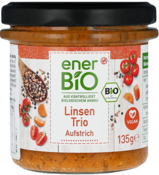 Bio pasta roślinna enerBiO Linsen Trio w szklanym słoiku z czarną zakrętką, etykieta z grafiką warzyw, widok z przodu.