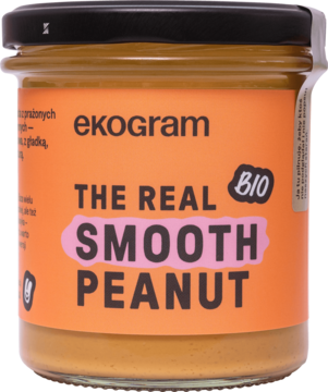 Kremowe masło orzechowe Ekogram BIO THE REAL SMOOTH PEANUT w szklanym słoiku z pomarańczową etykietą, widok z przodu.