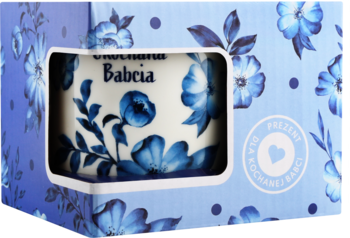 Mydło Original Babcia w niebiesko-białe kwiaty, widoczne w wycięciu niebieskiego opakowania z wzorem.