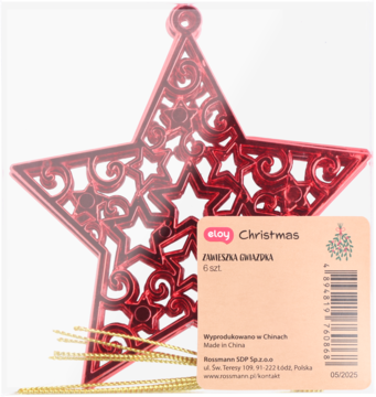 Czerwona, ażurowa ozdoba świąteczna w kształcie gwiazdy z wyciętymi wzorami, z etykietą i złotymi sznurkami.