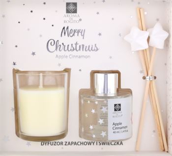 Biały zestaw świąteczny Aroma di Rogito: świeca i dyfuzor Apple Cinnamon w pudełku z gwiazdkami, z pałeczkami.
