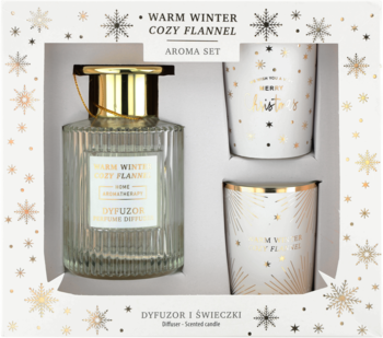 Zestaw zapachowy Warm Winter Cozy Flannel: dyfuzor i dwie świeczki, w białym pudełku ze złotymi śnieżynkami.