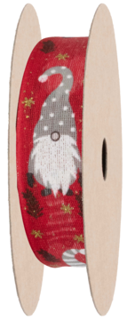 Czerwona wstążka świąteczna z wesołym krasnalem, brokatowymi gwiazdkami, na szpuli, widok z boku.