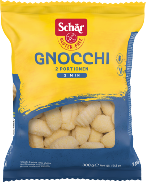 Żółto-niebieskie opakowanie Schär Gnocchi, bezglutenowe kopytka ziemniaczane, widoczne przez okienko.