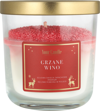 Świeca zapachowa Grzane Wino w szklanym słoiku ze złotą pokrywką, z brokatową czerwoną warstwą w środku.
