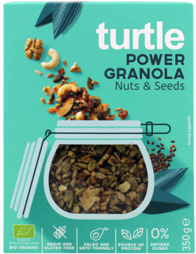 Zielone pudełko Turtle Power Granola Nuts & Seeds, bezglutenowa i keto, z widocznym słoikiem granoli.