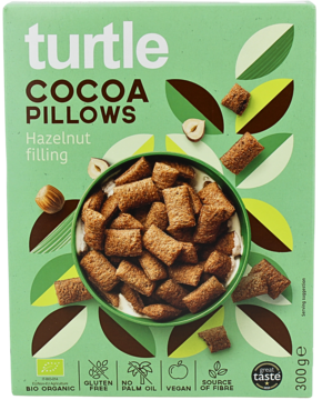 Zielone opakowanie płatków Turtle Cocoa Pillows Hazelnut filling, widok z przodu z miską pełną poduszek.