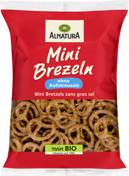 Czerwona torba Alnatura Mini Brezeln BIO, wegańskie precle bez soli, z widokiem na złociste chrupki.