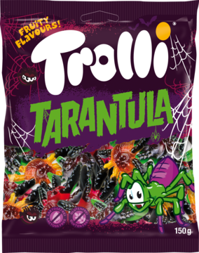 Fioletowa torebka żelków Trolli Tarantula, z przodu grafika pająków i hasło 'Fruity Flavours!'. Widać kolorowe żelki pająki.