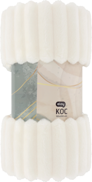 Zrolowany kremowy koc Eloy z miękkiego futra, z widoczną etykietą 'KOC', ułożony w dekoracyjne, faliste pasy.