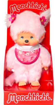 Różowa pluszowa lalka Monchhichi z bibem w kwiaty, uszy z kwiatami, w czerwonym pudełku, widok z przodu.