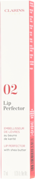 Białe opakowanie Clarins Lip Perfector 02 z masłem shea, z różowymi napisami i bocznym paskiem, widok z przodu.